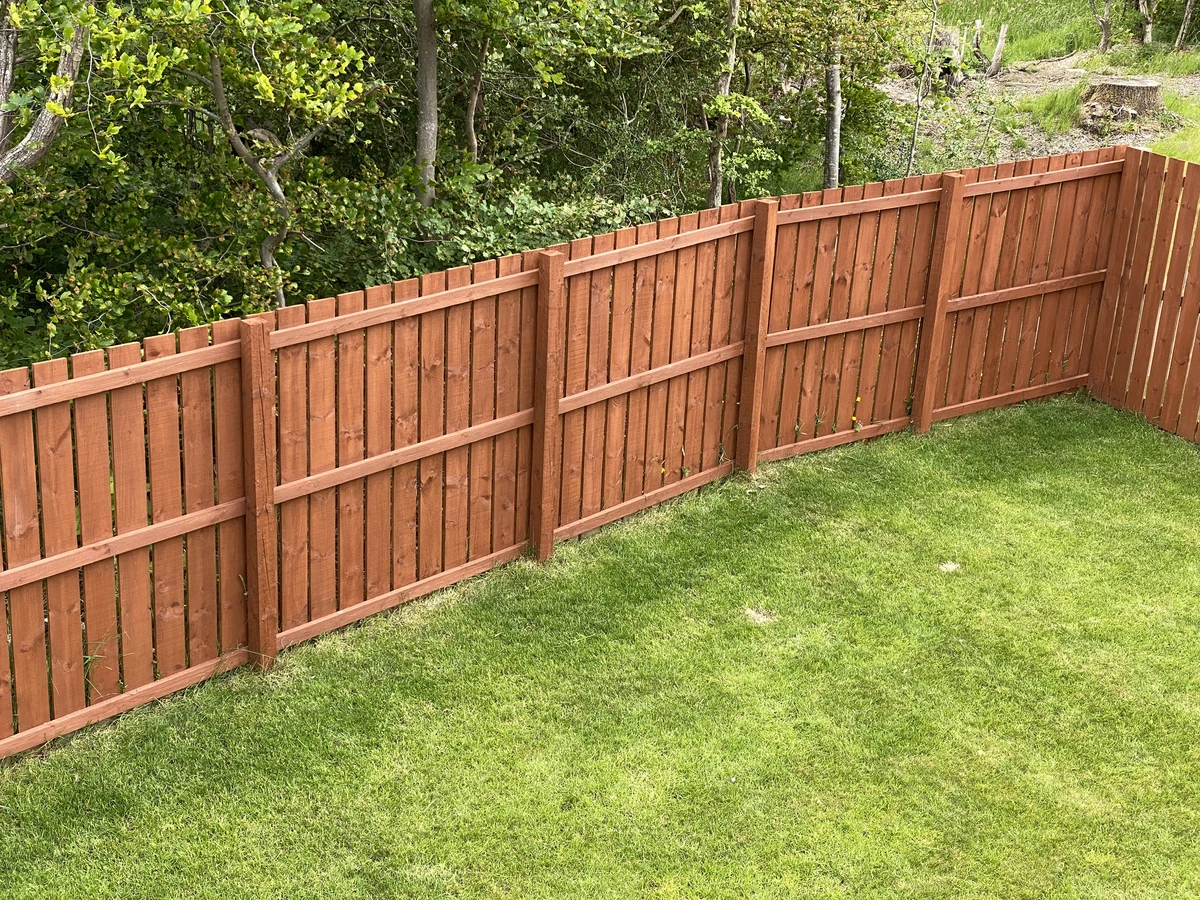 Brown stained wooden garden fence painted by Hampstead Decorators