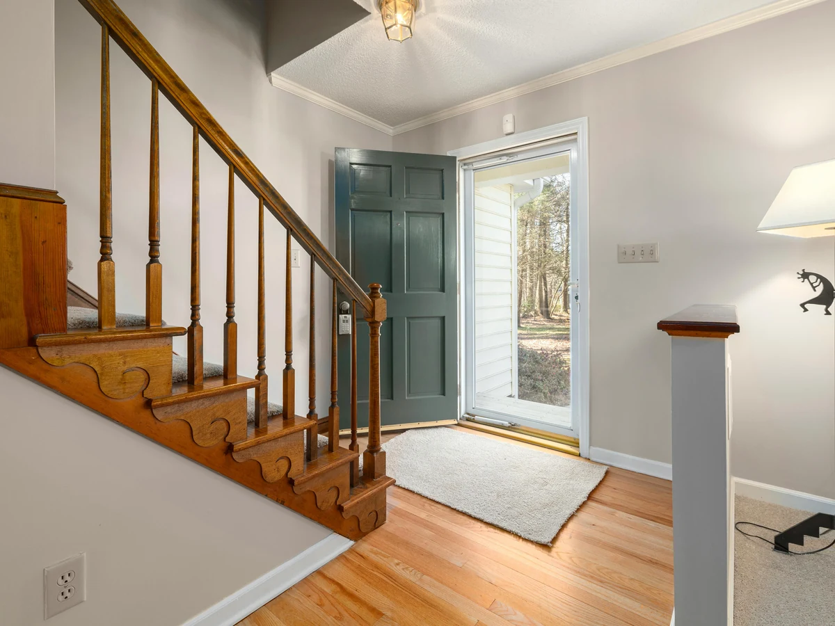 Hallway with varnished wood and painted walls by Hampstead Decorators