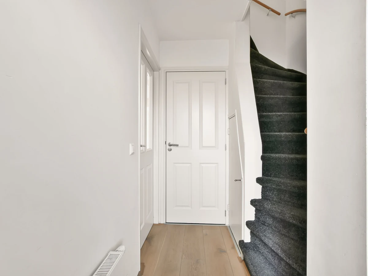Narrow white hallway painting in Hampstead by Hampstead Decorators