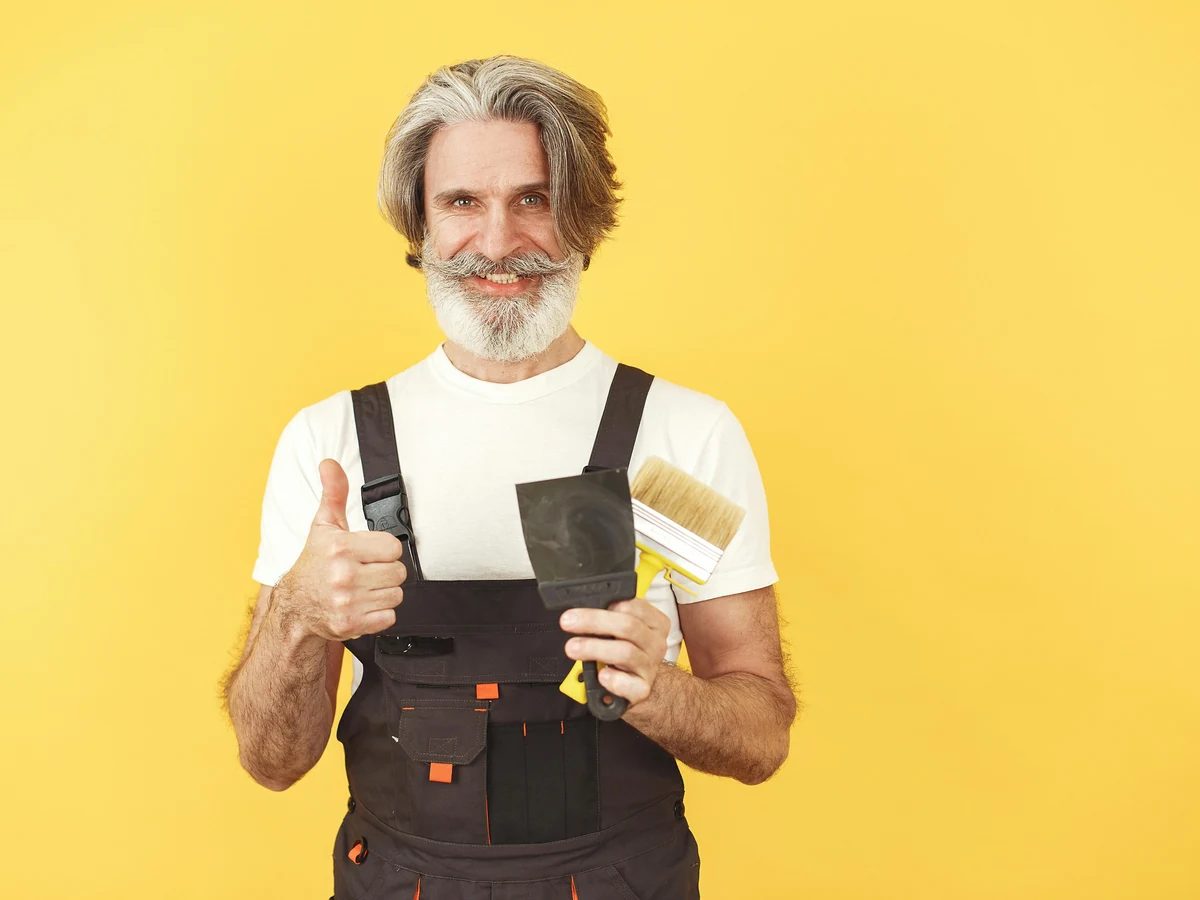 Hampstead Decorators painter in overalls assessing a Swiss Cottage property