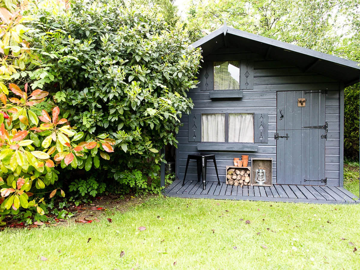 Dark stained wooden garden fence and structure in Hampstead